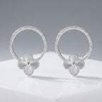Aretes flor halo de plata 925 con aro circular texturizado