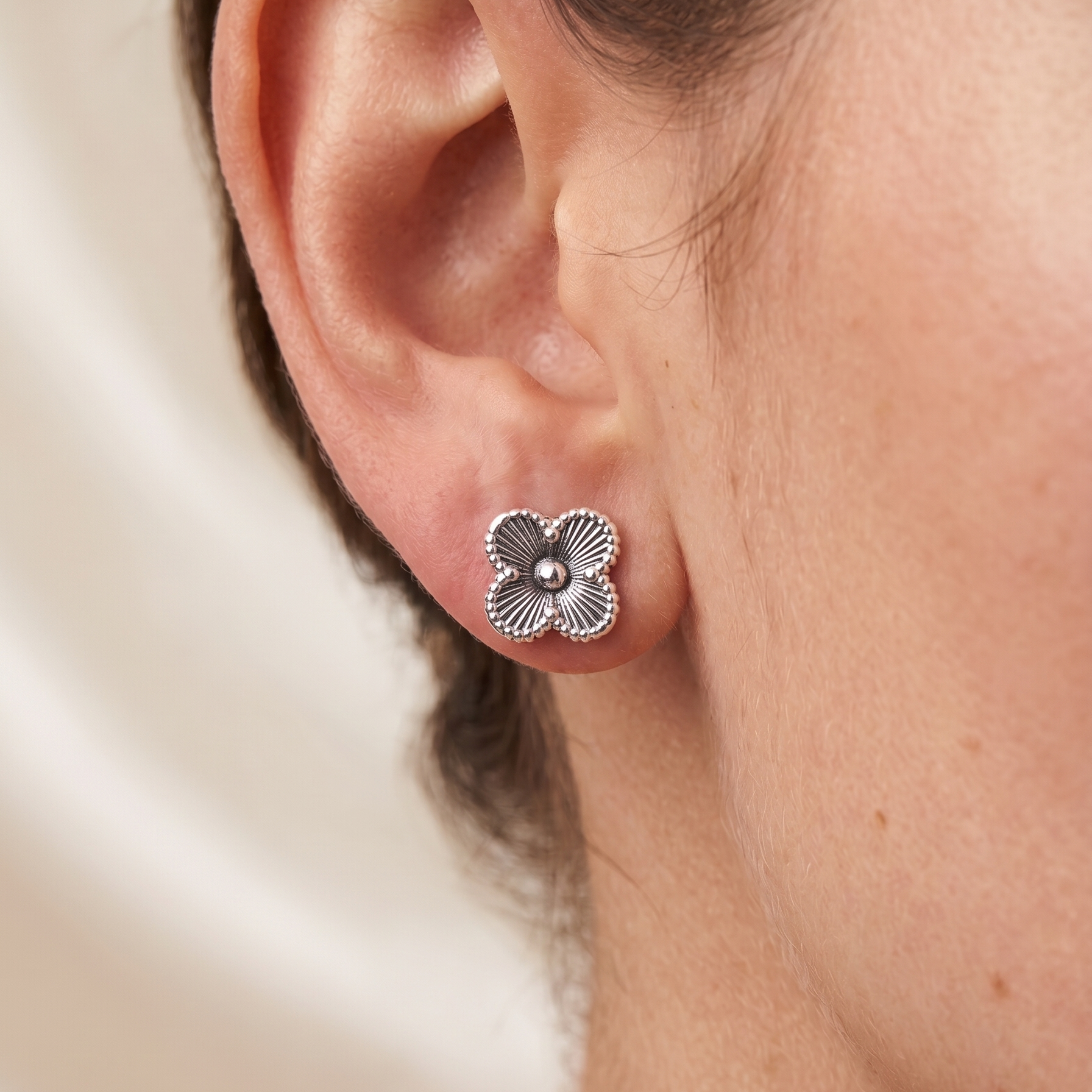 Aretes flor de plata 925 de 1 cm con broche tipo mariposa sobre oreja